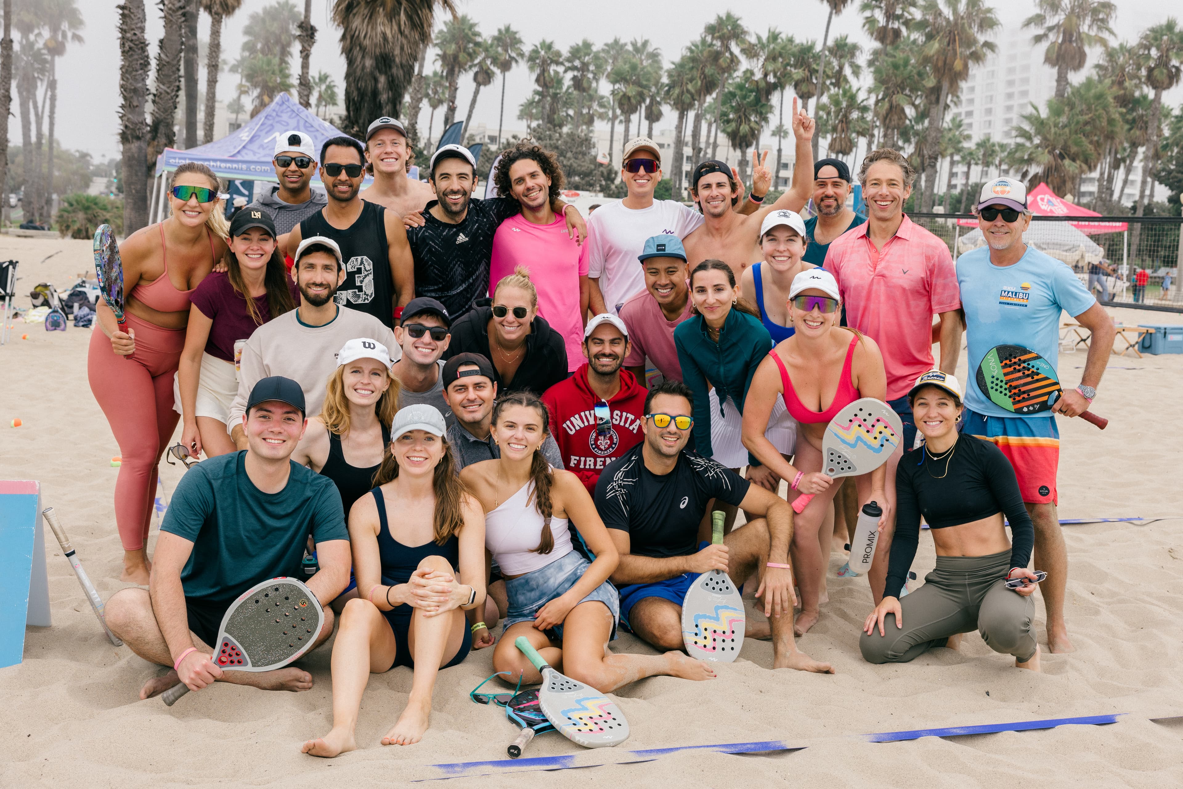 On the sand — OLA players celebrating at the net